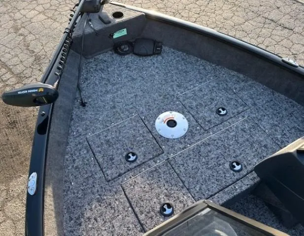 Slide: The Image of 2026 Tracker Pro Guide V-16 WT boat deck with storage compartments and trolling motor. - 6