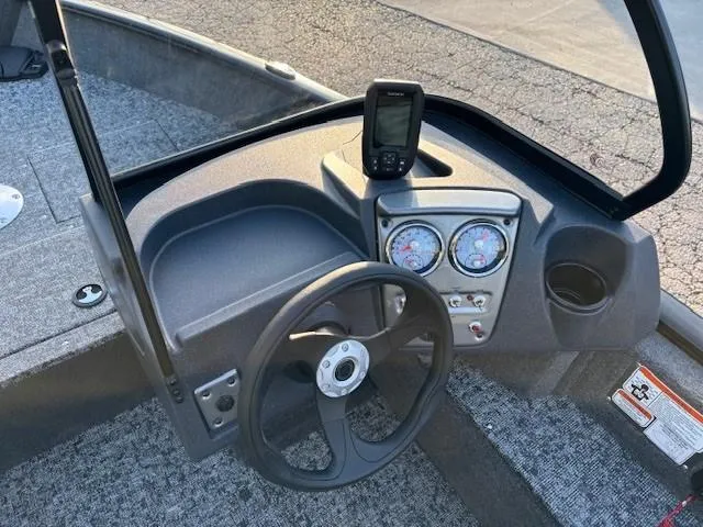 Slide: The Image of 2026 Tracker Pro Guide V-16 WT boat dashboard with steering wheel and gauges. - 8