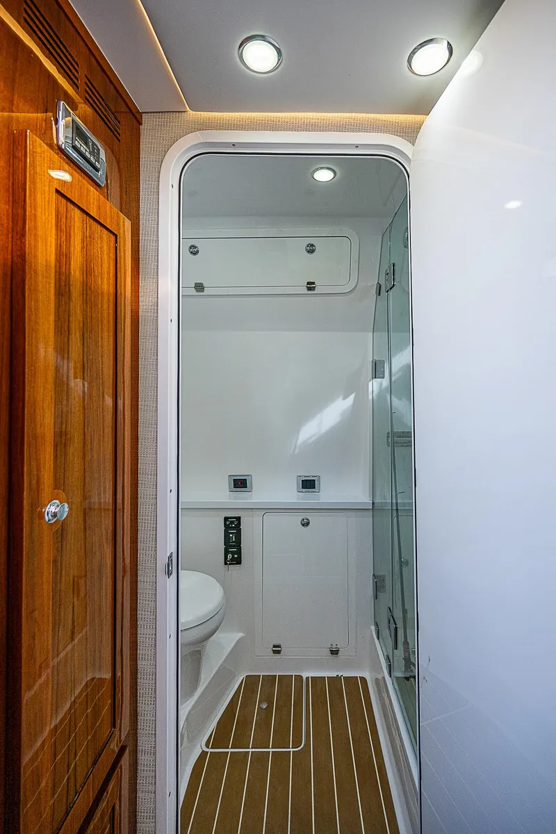 Slide: The Image of Luxurious 2022 HCB 53 yacht bathroom with modern fixtures and wood accents. - 12