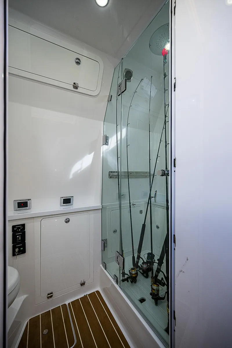 Slide: The Image of 2022 HCB 53 interior with fishing rod storage and sleek design. - 13