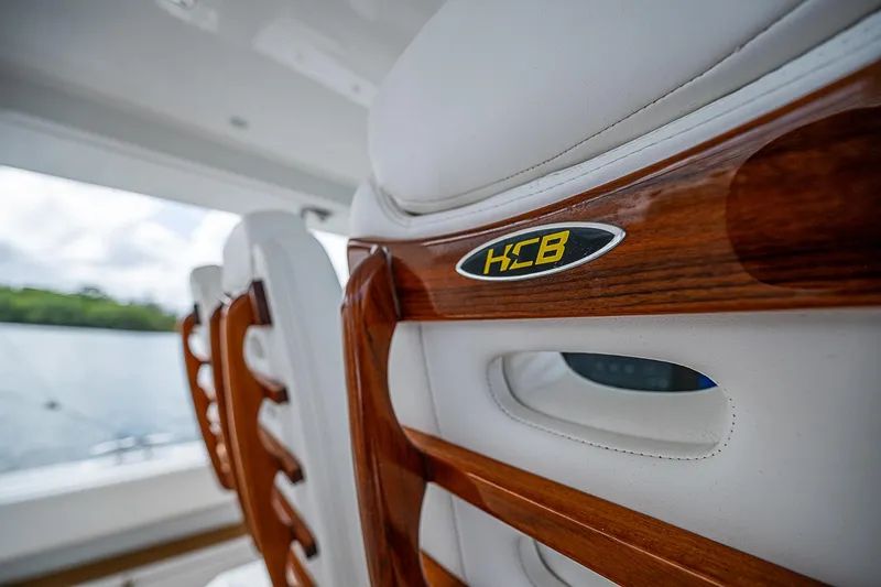 Slide: The Image of Luxury seating on 2022 HCB 53 boat with wooden accents. - 15