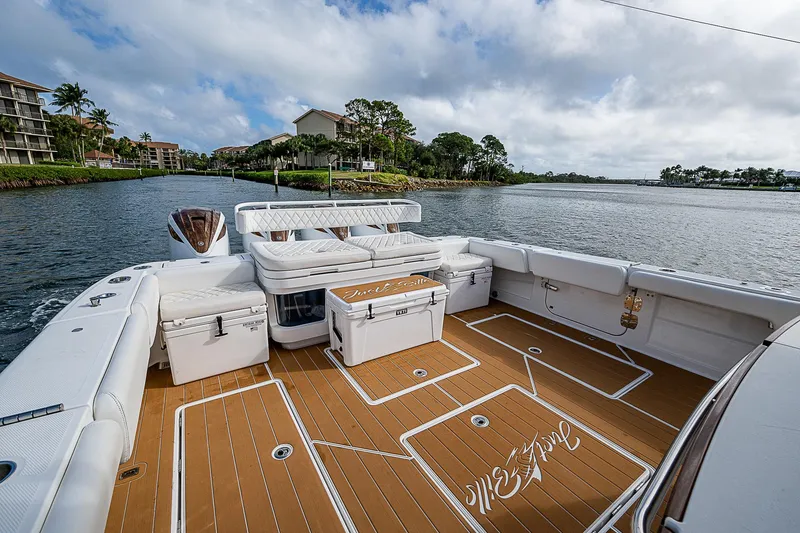 Slide: The Image of Luxurious 2022 HCB 53 boat deck with seating, on a scenic waterfront. - 16