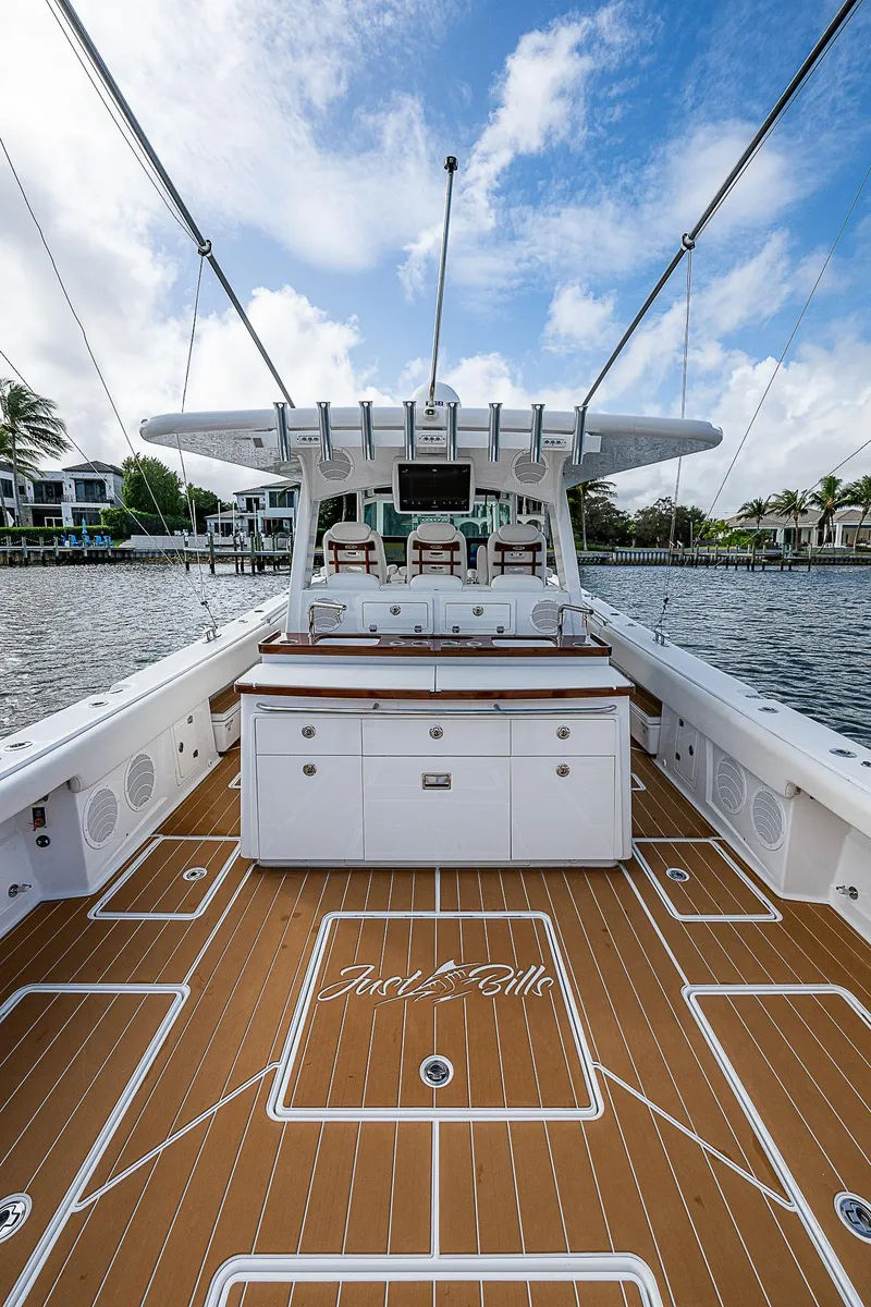 Slide: The Image of 2022 HCB 53 yacht with spacious deck and luxurious seating on a sunny day. - 18