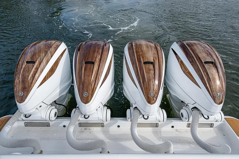 Slide: The Image of Four Yamaha outboard engines on a 2022 HCB 53 boat, featuring wood accents. - 19