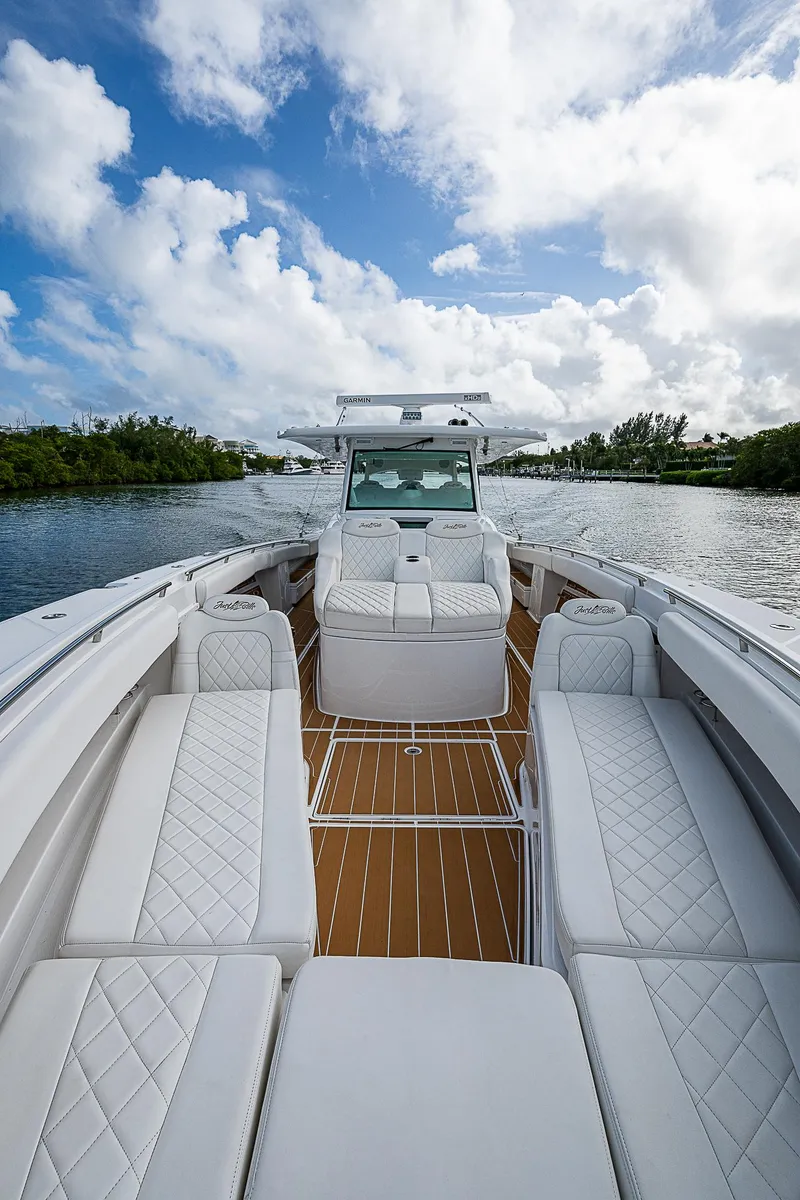 Slide: The Image of Luxurious 2022 HCB 53 boat with white seating and wooden deck on a sunny day. - 4