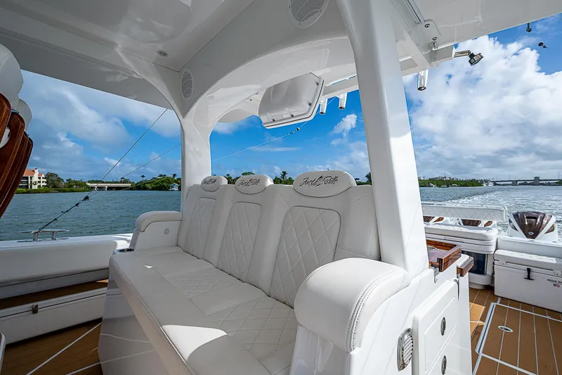 Slide: The Image of Luxurious 2022 HCB 53 yacht interior with plush white seating and scenic water view. - 7