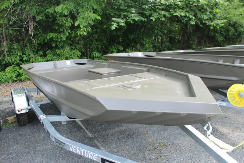 Slide: The Image of 2025 WeldBilt 1548V boat on trailer, surrounded by lush greenery. - 1