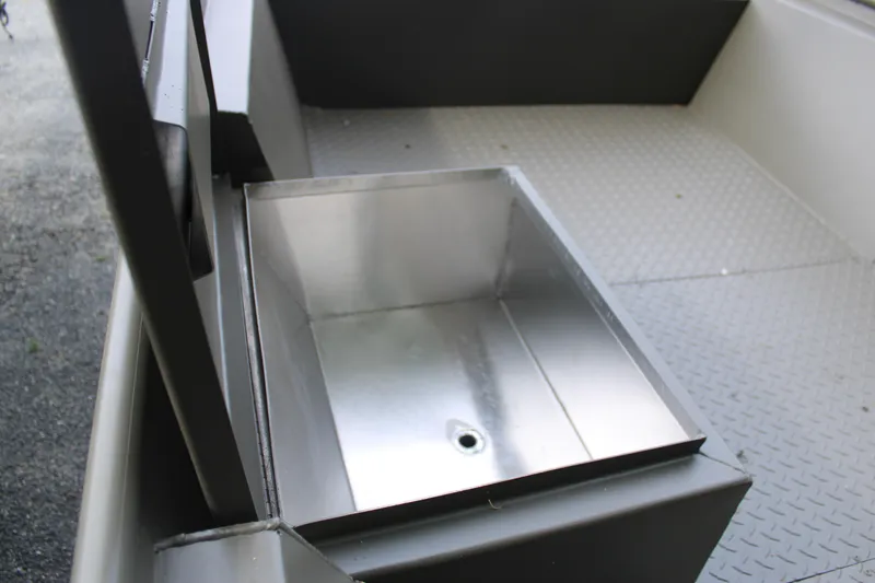 Slide: The Image of Open storage compartment in 2025 WeldBilt 1548V boat with diamond plate flooring. - 3