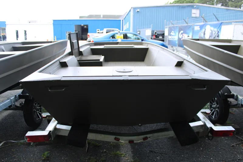 Slide: The Image of 2025 WeldBilt 1548V boat on trailer, parked outdoors near blue building. - 5