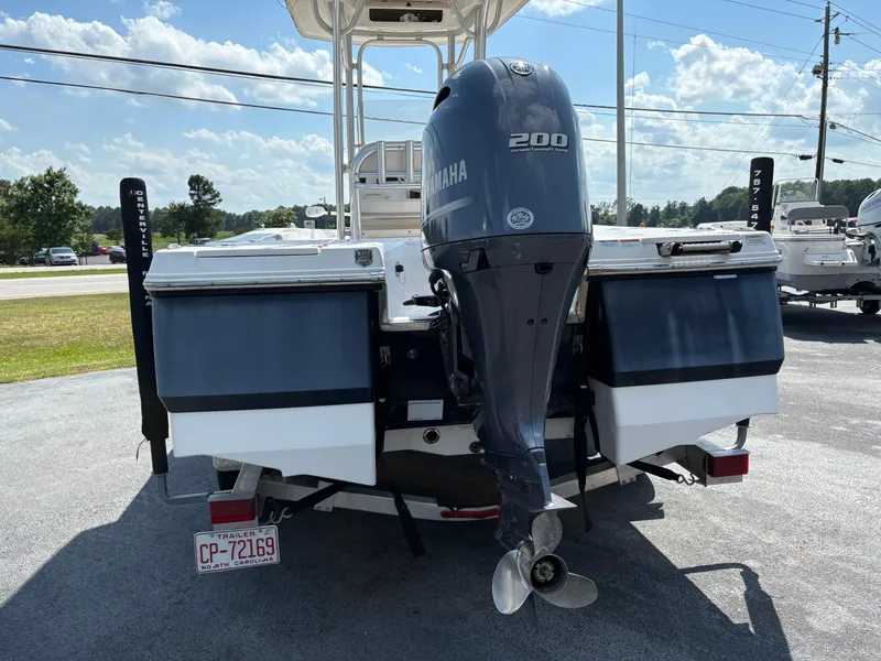 Slide: The Image of 2017 Robalo 226 Cayman boat with Yamaha 200 engine, parked outdoors. - 4