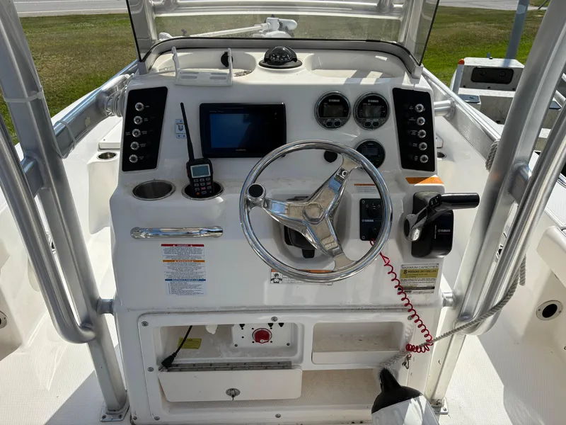Slide: The Image of 2017 Robalo 226 Cayman boat dashboard with steering wheel and control panel. - 5