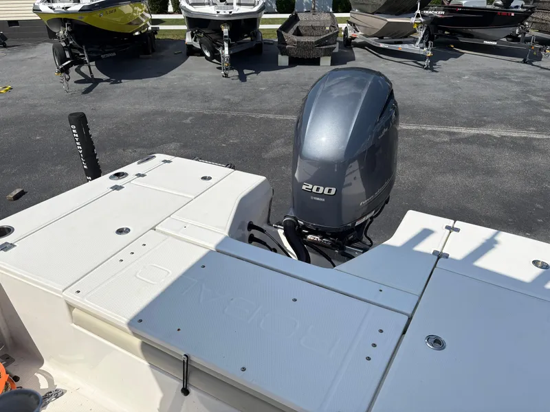 Slide: The Image of 2017 Robalo 226 Cayman boat with Yamaha 200 engine, parked on asphalt. - 6