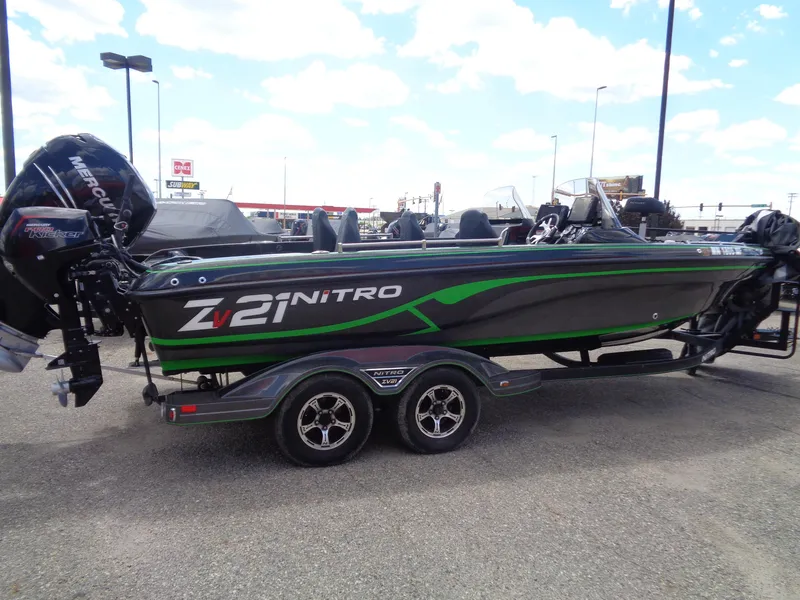 Slide: The Image of 2022 Nitro ZV21 boat with Mercury engine, parked on a trailer in a lot. - 3