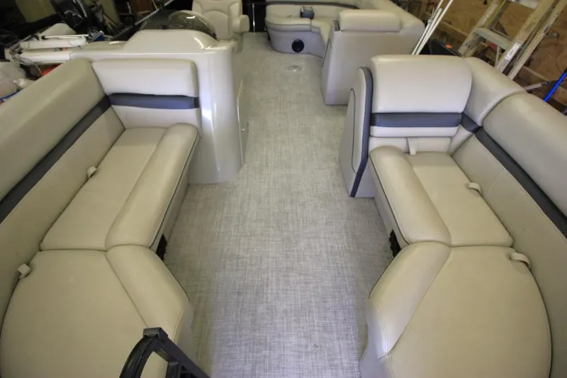 Slide: The Image of 2017 South Bay 222 CR pontoon boat interior with beige seating and spacious layout. - 13