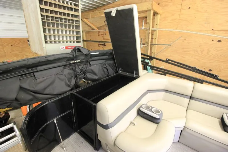 Slide: The Image of 2017 South Bay 222 CR pontoon boat interior with beige seating and storage compartment. - 14
