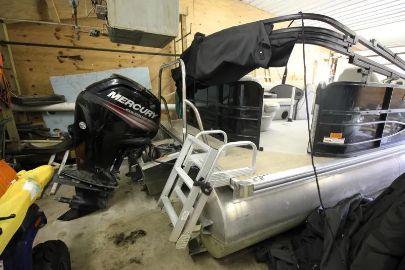 Slide: The Image of 2017 South Bay 222 CR pontoon boat with Mercury outboard motor in a garage. - 15