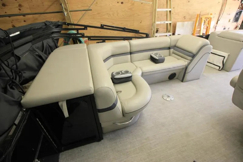 Slide: The Image of 2017 South Bay 222 CR pontoon boat interior with beige seating and cup holders. - 5