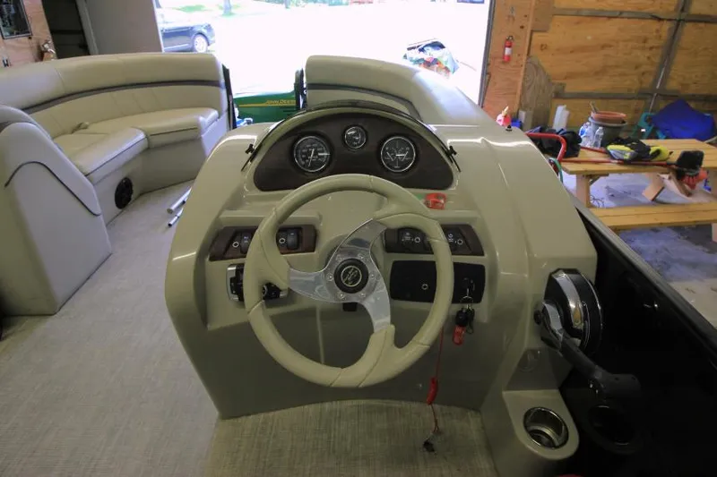 Slide: The Image of 2017 South Bay 222 CR boat interior with steering wheel and dashboard controls. - 7