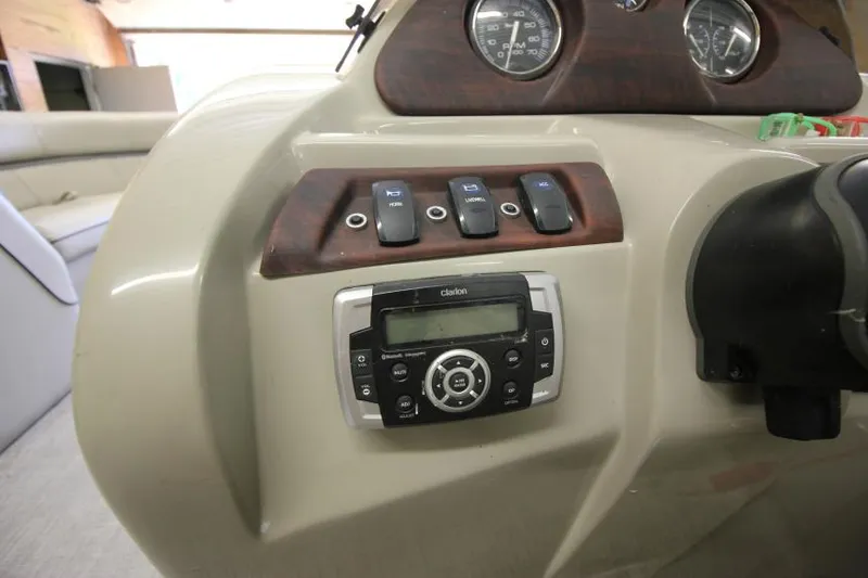 Slide: The Image of 2017 South Bay 222 CR boat dashboard with controls and Clarion stereo system. - 8