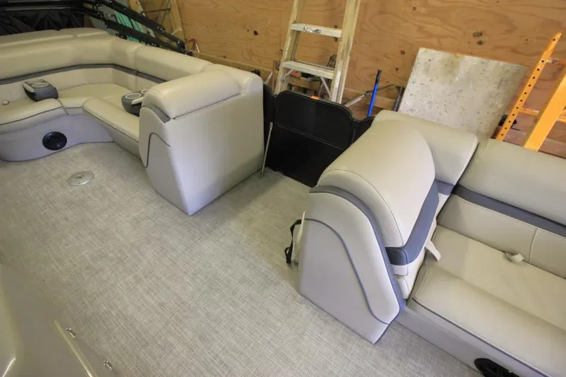 Slide: The Image of 2017 South Bay 222 CR boat interior with beige seating and storage compartments. - 9