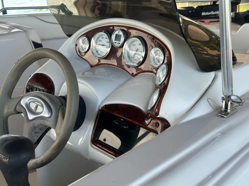 Slide: The Image of 2005 Tahoe 195 OB boat dashboard with steering wheel and gauges. - 36