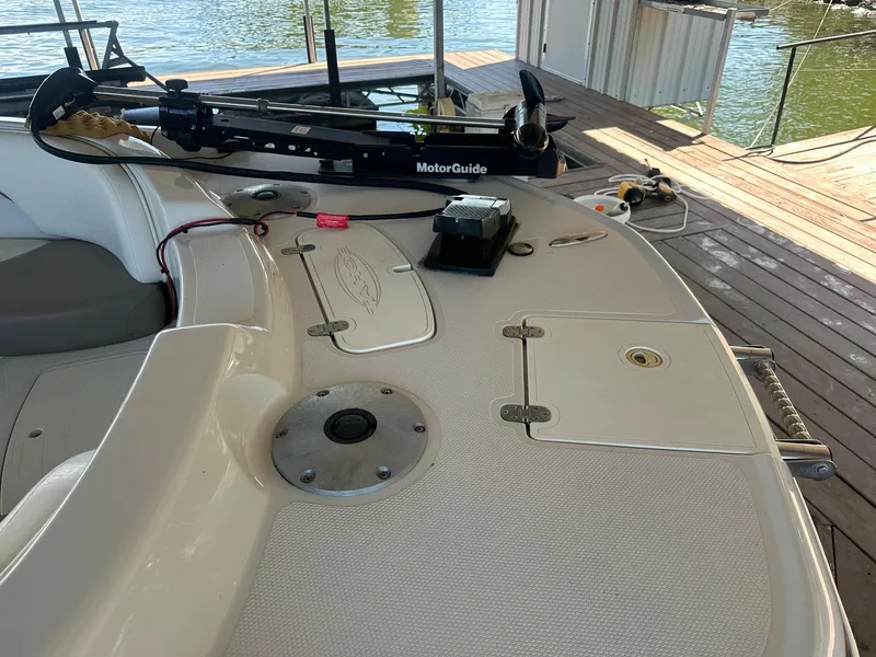 Slide: The Image of 2005 Tahoe 195 OB boat deck with MotorGuide trolling motor, docked by the water. - 39