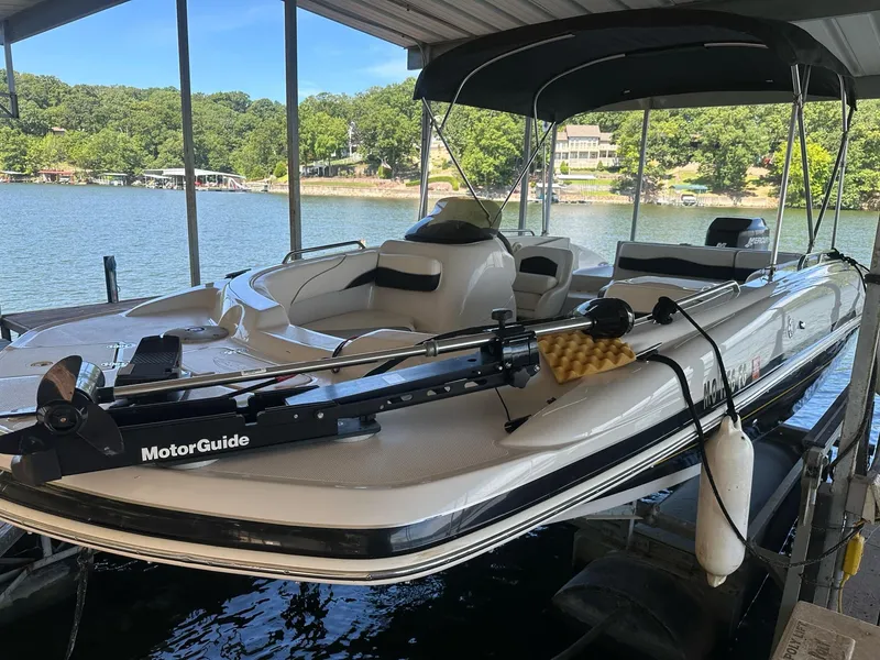 Slide: The Image of 2005 Tahoe 195 OB boat docked with MotorGuide trolling motor, scenic lake view. - 40