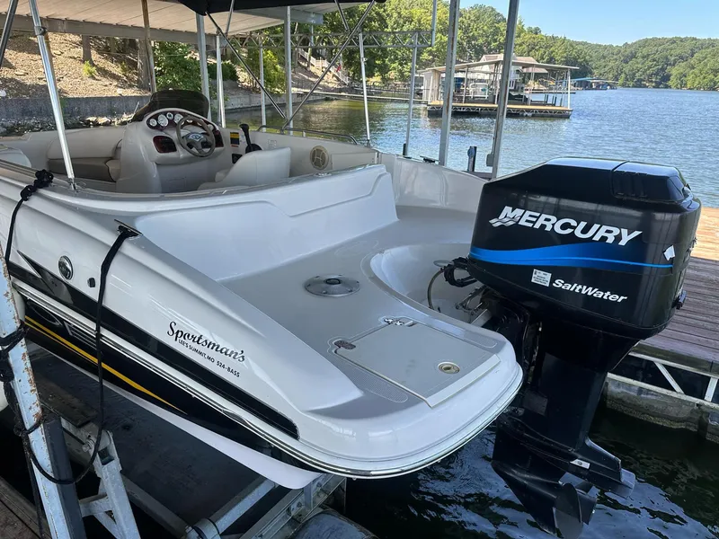 Slide: The Image of 2005 Tahoe 195 OB boat with Mercury SaltWater engine docked by a lake. - 42
