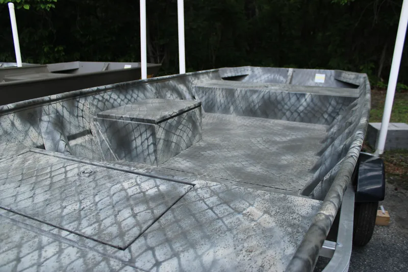 Slide: The Image of 2025 WeldBilt 1648V boat with camouflage pattern, parked on a trailer. - 2