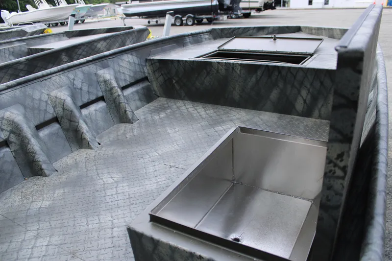 Slide: The Image of 2025 WeldBilt 1648V boat interior with storage compartments and textured flooring. - 3
