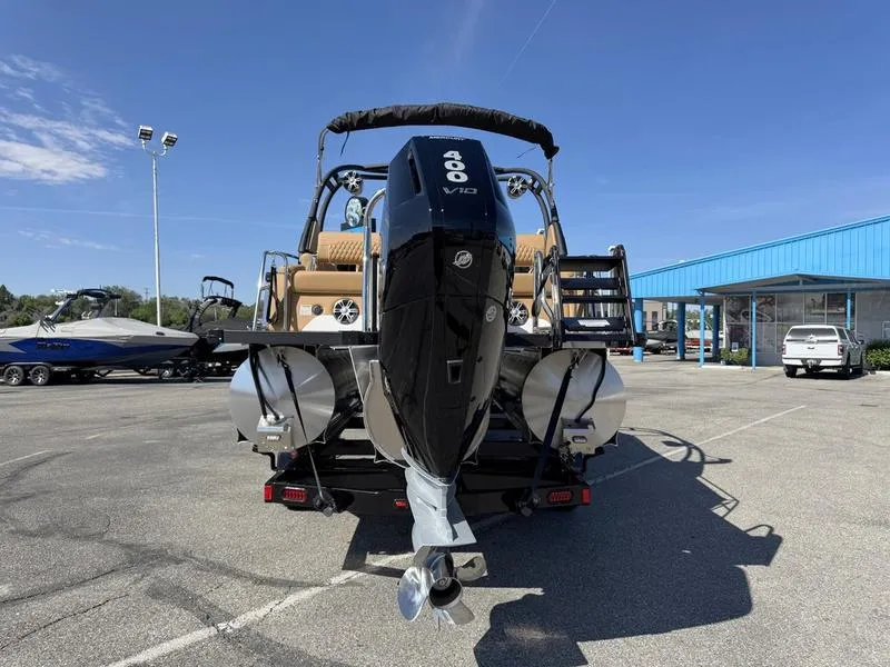 Slide: The Image of 2025 Avalon 2585 27-3 Excalibur LTD QL boat with powerful 400 V10 engine, parked outdoors. - 11