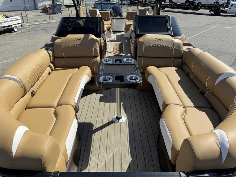 Slide: The Image of Luxurious 2025 Avalon 2585 27-3 Excalibur LTD QL pontoon boat with plush seating and table. - 19