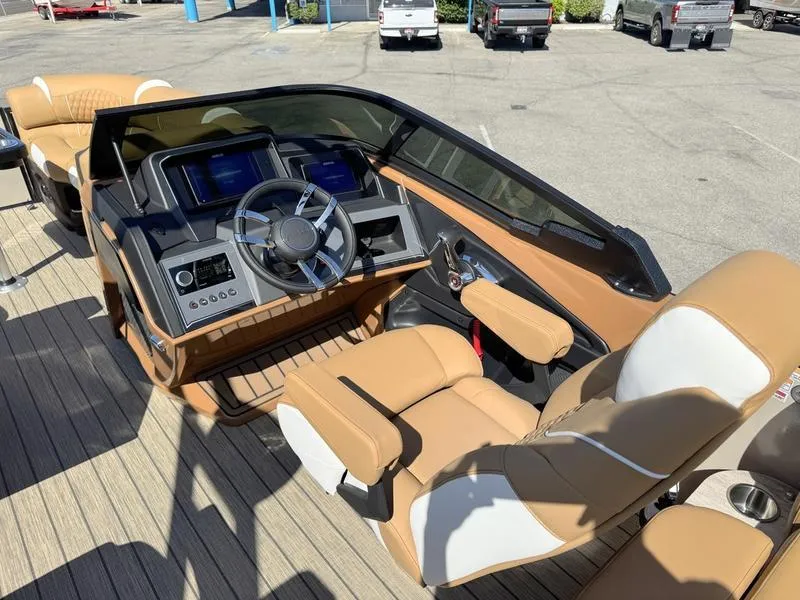 Slide: The Image of Luxurious 2025 Avalon 2585 27-3 Excalibur LTD QL boat interior with tan seating and modern dashboard. - 6