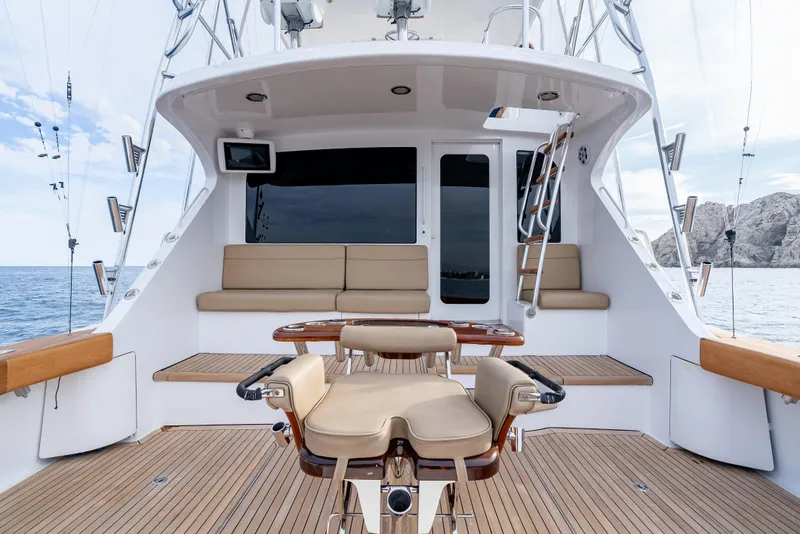 Slide: The Image of Hatteras 60 Convertible 2010 yacht deck with seating, fishing chair, and ocean view. - 13