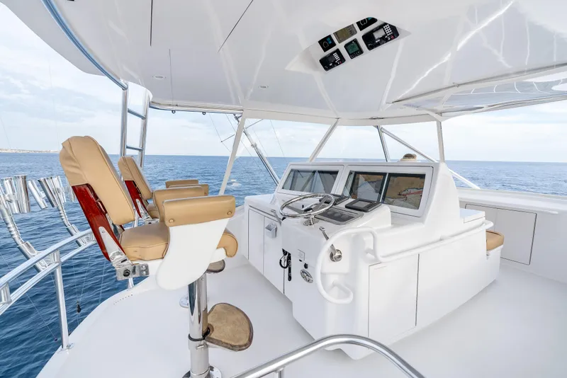 Slide: The Image of Helm of 2010 Hatteras 60 Convertible yacht with ocean view and modern controls. - 15