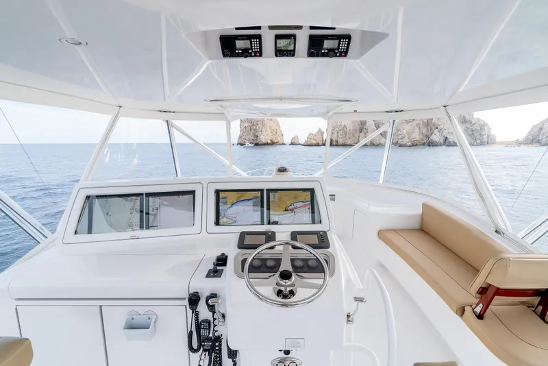 Slide: The Image of Helm of 2010 Hatteras 60 Convertible yacht with navigation screens and ocean view. - 16