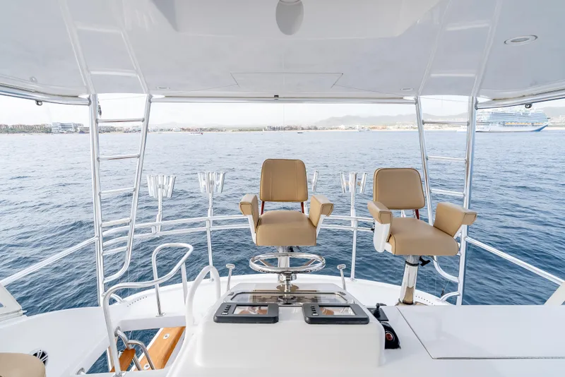 Slide: The Image of Flybridge view of 2010 Hatteras 60 Convertible yacht with ocean backdrop. - 17