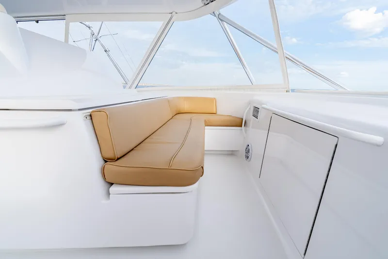 Slide: The Image of Luxurious seating area on 2010 Hatteras 60 Convertible yacht with tan cushions. - 18