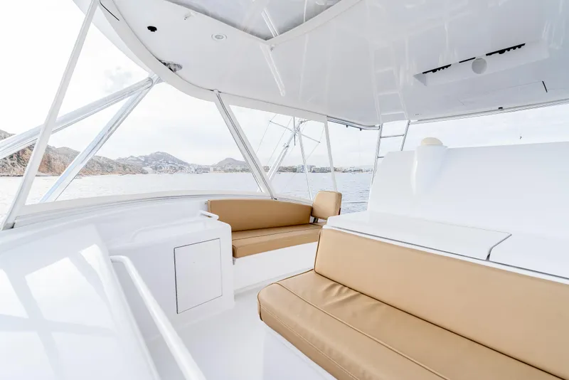 Slide: The Image of Luxurious interior of 2010 Hatteras 60 Convertible yacht with beige seating and ocean view. - 19
