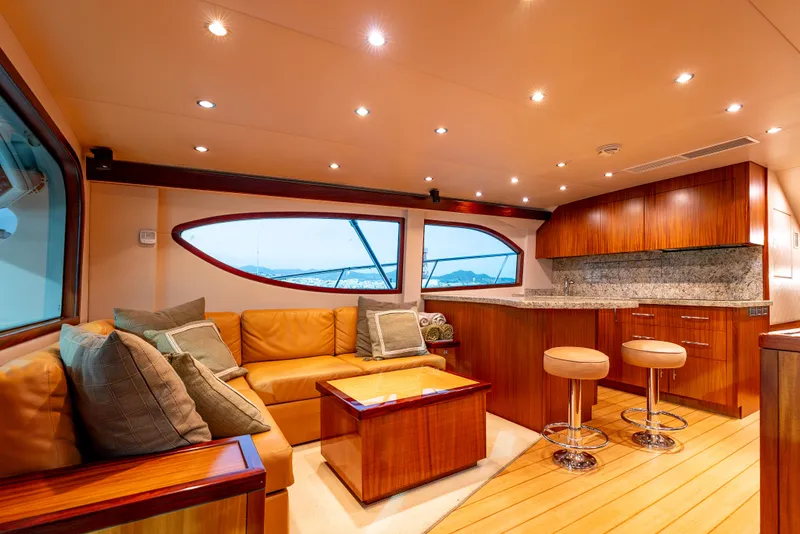 Slide: The Image of Luxurious interior of 2010 Hatteras 60 Convertible yacht with plush seating and modern kitchen. - 20