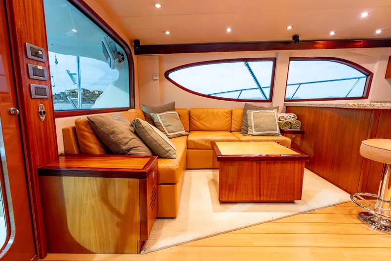 Slide: The Image of Luxurious interior of 2010 Hatteras 60 Convertible yacht with leather seating and wooden accents. - 22