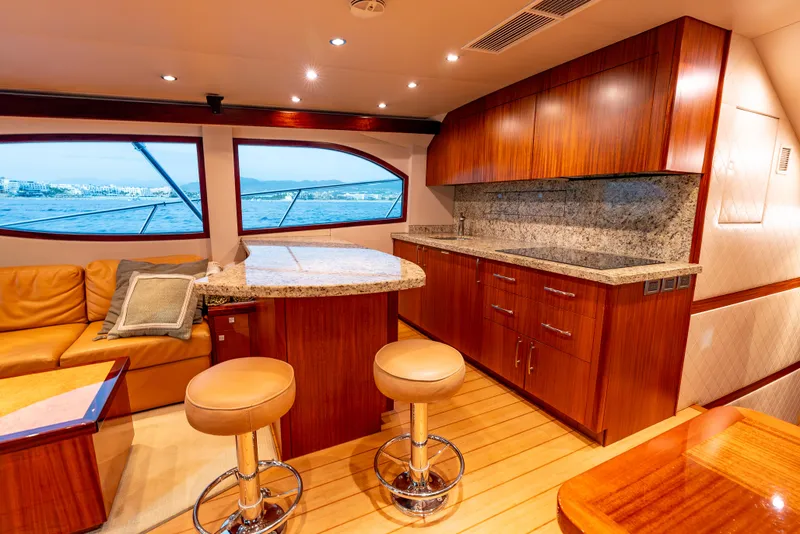 Slide: The Image of Luxurious interior of 2010 Hatteras 60 Convertible yacht with modern kitchen and seating area. - 24