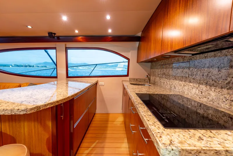 Slide: The Image of Luxurious kitchen interior of 2010 Hatteras 60 Convertible yacht with granite countertops and ocean view. - 26