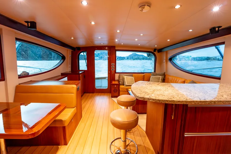 Slide: The Image of Luxurious interior of 2010 Hatteras 60 Convertible yacht with elegant seating and panoramic windows. - 28