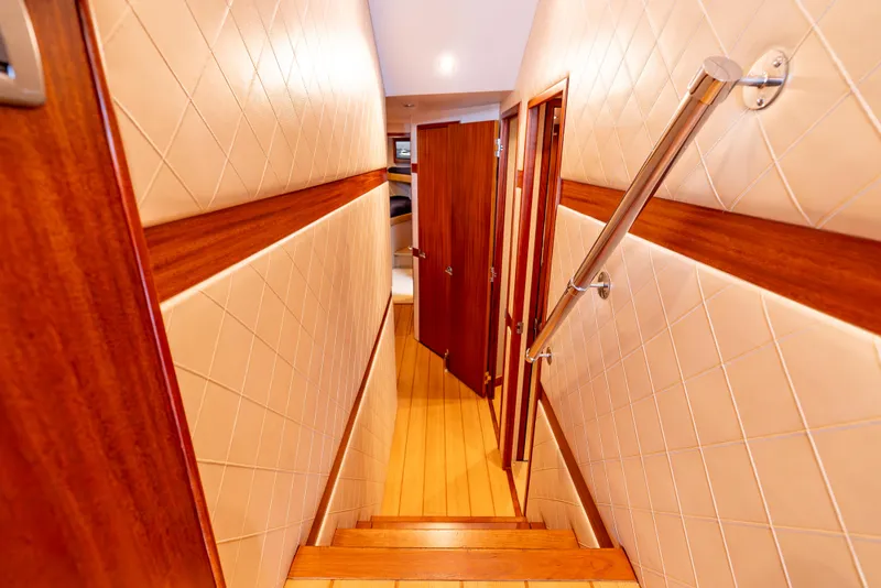 Slide: The Image of Interior hallway of 2010 Hatteras 60 Convertible yacht with wooden doors and handrail. - 30