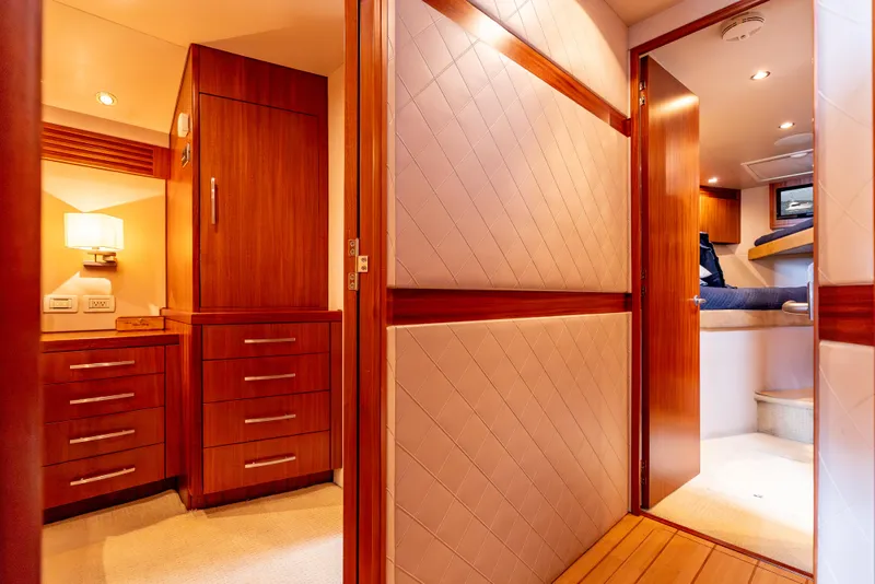 Slide: The Image of Luxurious interior of 2010 Hatteras 60 Convertible yacht with wood cabinetry and cozy lighting. - 31