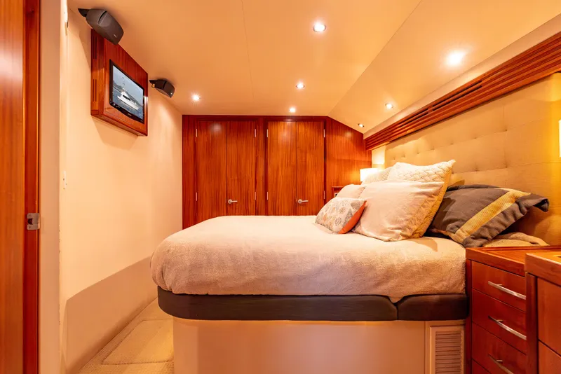 Slide: The Image of Luxurious bedroom interior of 2010 Hatteras 60 Convertible yacht with plush bedding and wood accents. - 33