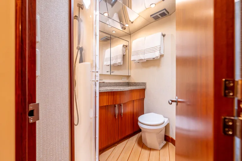 Slide: The Image of Luxurious bathroom in 2010 Hatteras 60 Convertible yacht with modern fixtures and wooden accents. - 35