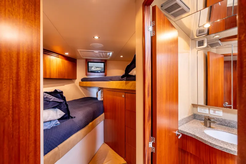 Slide: The Image of Interior of 2010 Hatteras 60 Convertible yacht with cozy bunk beds and wooden cabinetry. - 41
