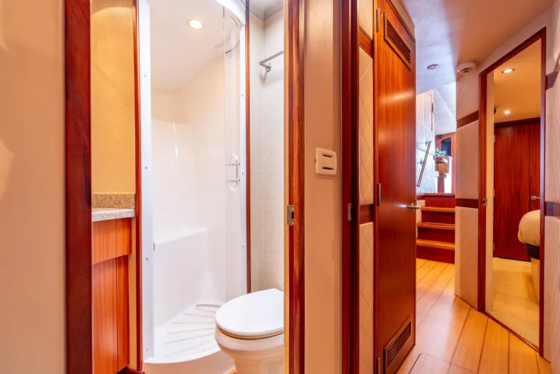 Slide: The Image of Interior of 2010 Hatteras 60 Convertible yacht featuring bathroom and hallway with wooden accents. - 44